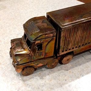 Model bronze and copper tone tractor trailer.  Musical wind up also.